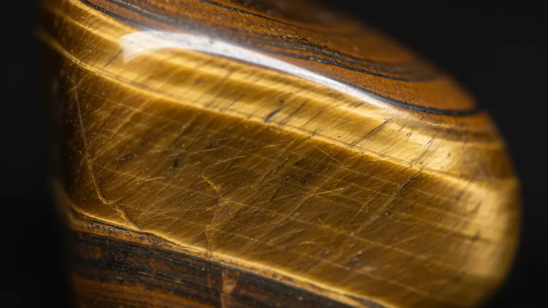 Ojo de tigre en primer plano mostrando el efecto chatoyance dorado característico de esta piedra natural