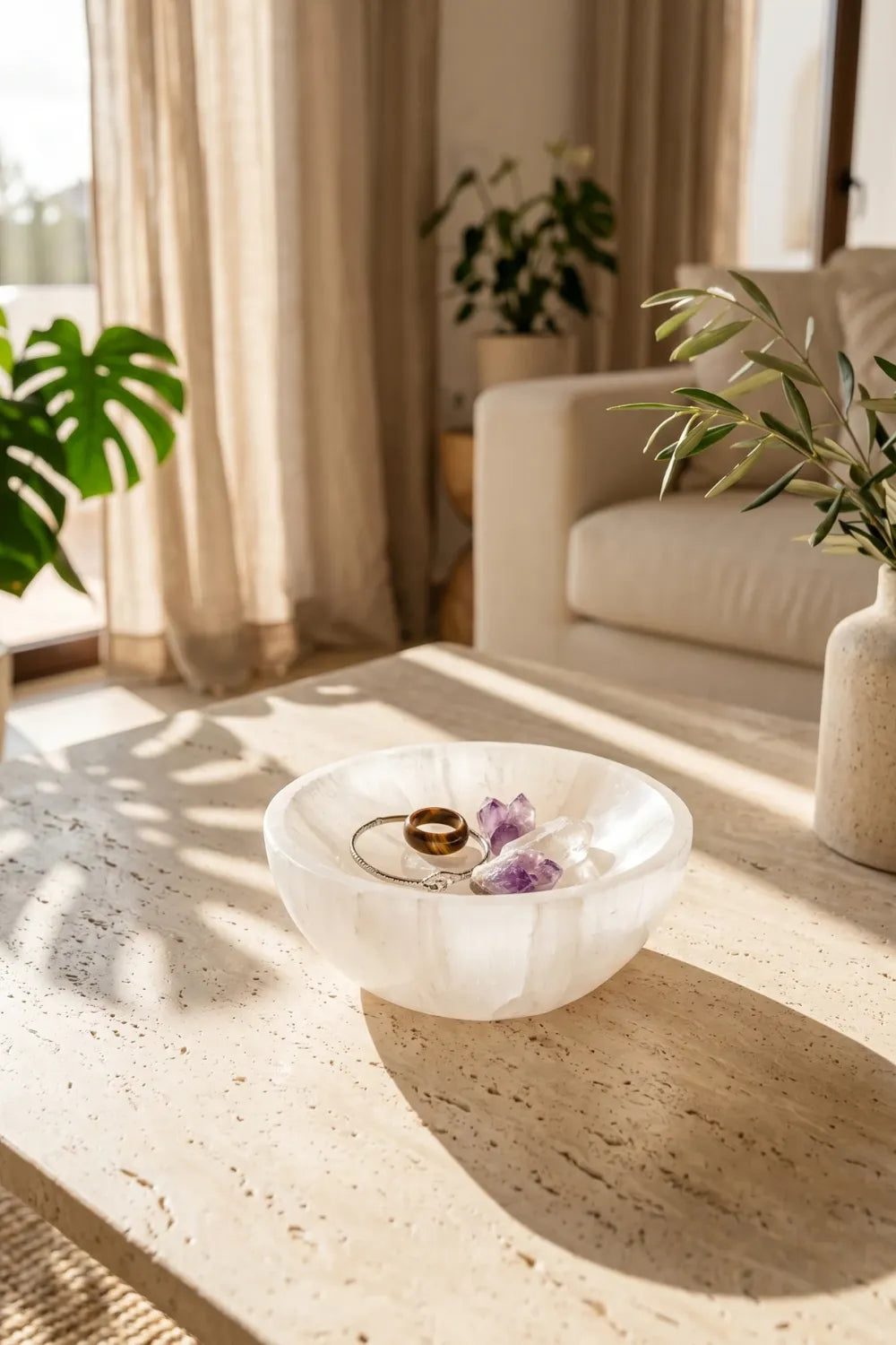 Cuenco de selenita blanco sobre mesa de salón con joyas y decoración natural - Anna Piedra